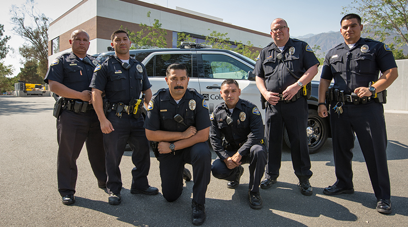 Chaffey College Police Officers standing in front of a patrol vehicle