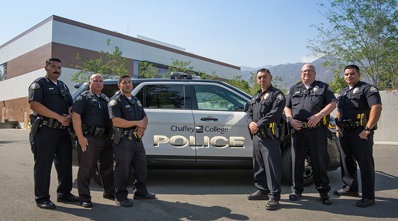 Chaffey College Police Officers standing in front of a patrol vehicle
