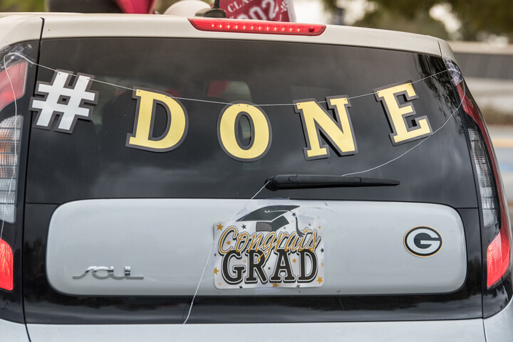 Rear windshield of a car with the word #Done written on it