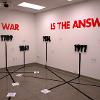 Evelin Gonzalez Padilla, “World at War,” 2022. Installation of paper, duct tape, foam board, light and sound.