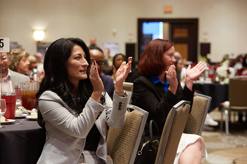 Educational leader clapping her hands