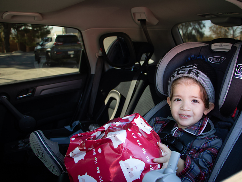A child in a car at the Pantry Christmas Event