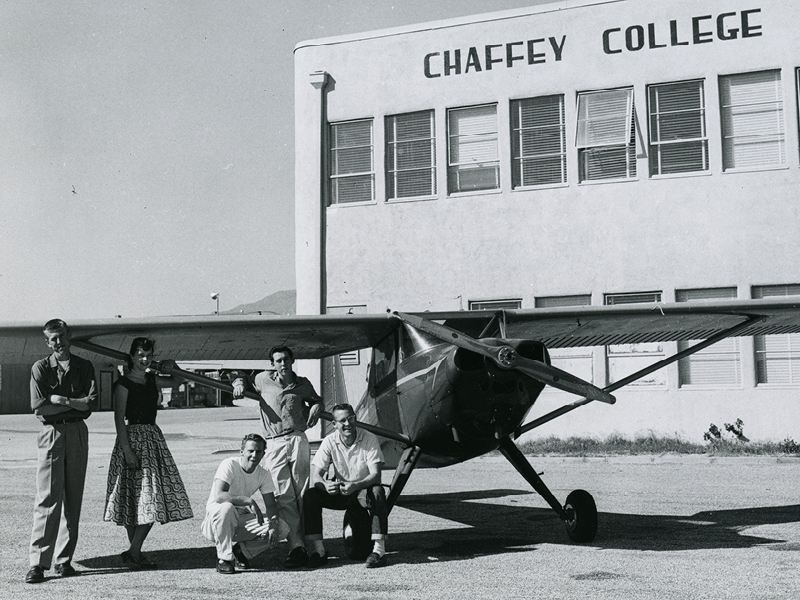 1952 Aeronautics. Students in front of airplane and Aeronautics building