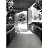 Open corridor formed by concrete piers and flat roof.