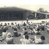 DOMESTIC SCALE: Most of the original buildings were single story with a low gable roof, typical of suburban residential architecture of the era. Here, students gather at the Campus Center.