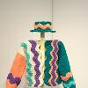 Mackenzie Bussola, “Wavy Sweater & Hat,” 2023. Acrylic thrifted yarn and an unraveled sweater. 19 x 57 inches, 4 x 13.5 x 31. 