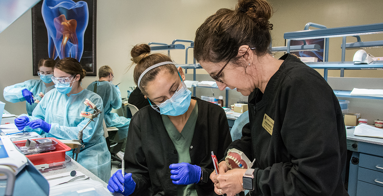 two students learning prosthetic dentistry