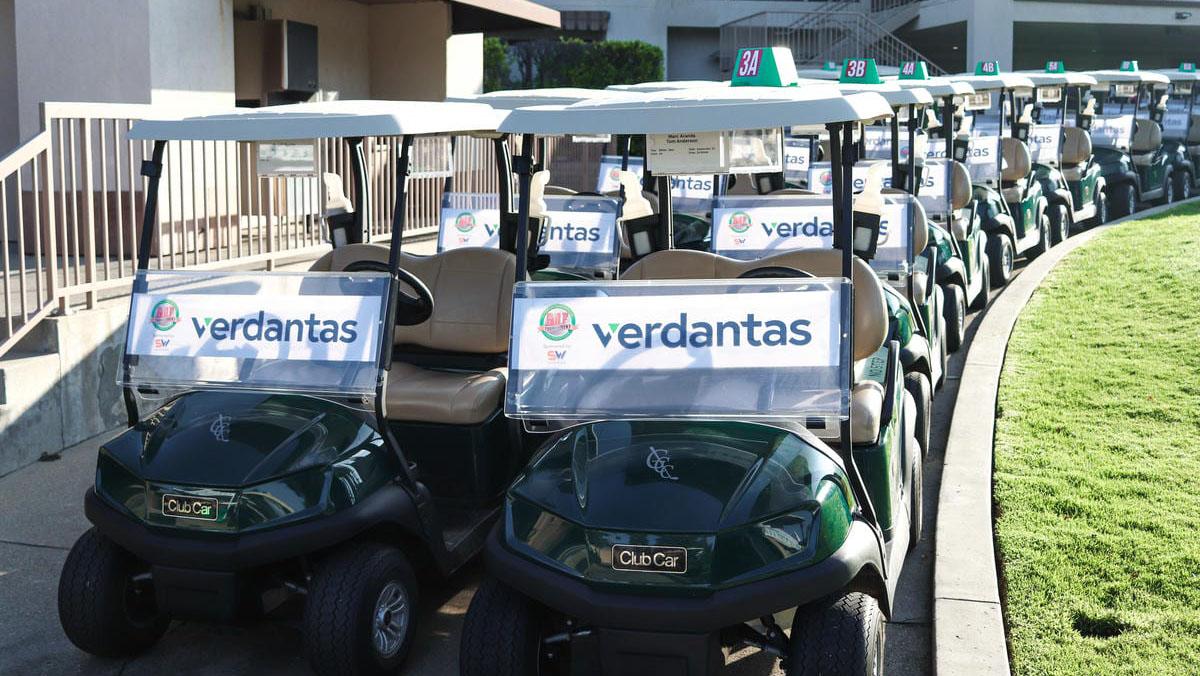 A sunny photo shows dark green Club Car golf carts lined up, each with a verdantas banner on the windshield.