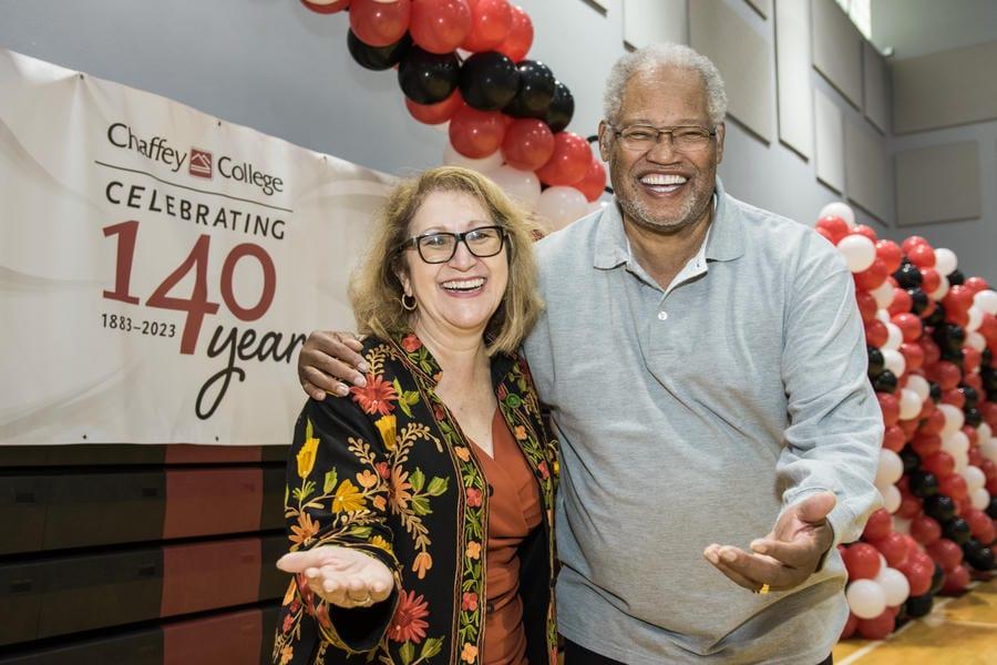 Dr. Henry Shannon and one individual laughing together at Chaffey College's 140th anniversary celebration.