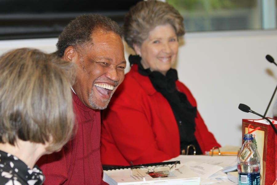 Dr. Shannon laughs with 2 others at a Chaffey College governing board meeting.