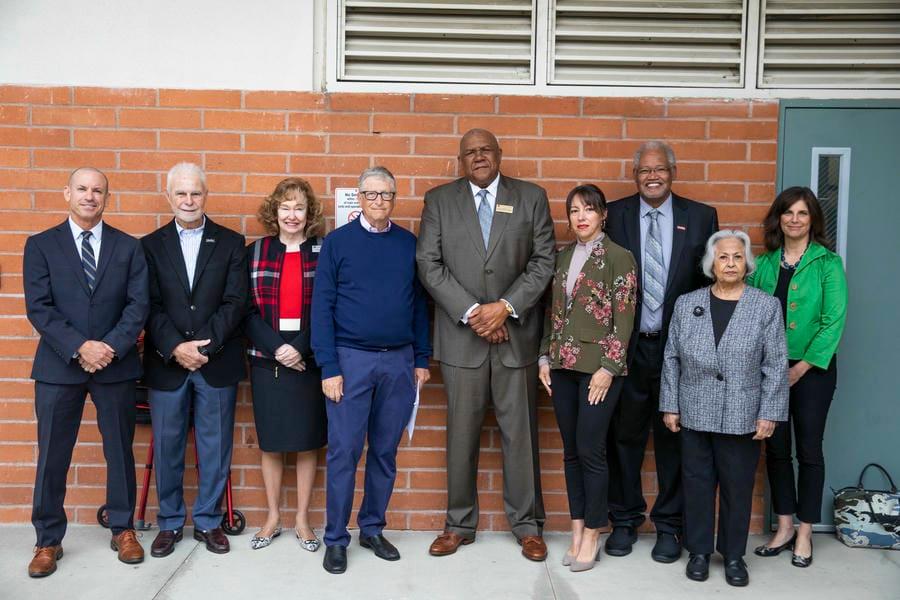 Dr. Shannon and seven others smile with Bill Gates during his visit to Chaffey College InTech Center in 2023.