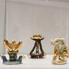 Adina Andrus, “New Lares #3: Nerio,” 2024; “New Lares #7: Gratiae,” 2024; “New Lares #8: Antevorta,” 2024. Glazed ceramic, luster, bioplastic, and 24k gold leaf. 3 inches tall.