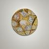 Marjan Khoshbakhti Vayghan, “My Brain Keeps Golden Ancestral Rackets,” 2015–2026. Oil, acrylic, inherited fabrics, drawing, writing, and handmade gold-leaf flowers on a handmade circular support. 47 inches in diameter.