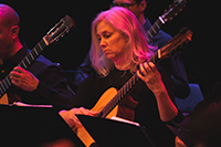 female musician playing a guitar