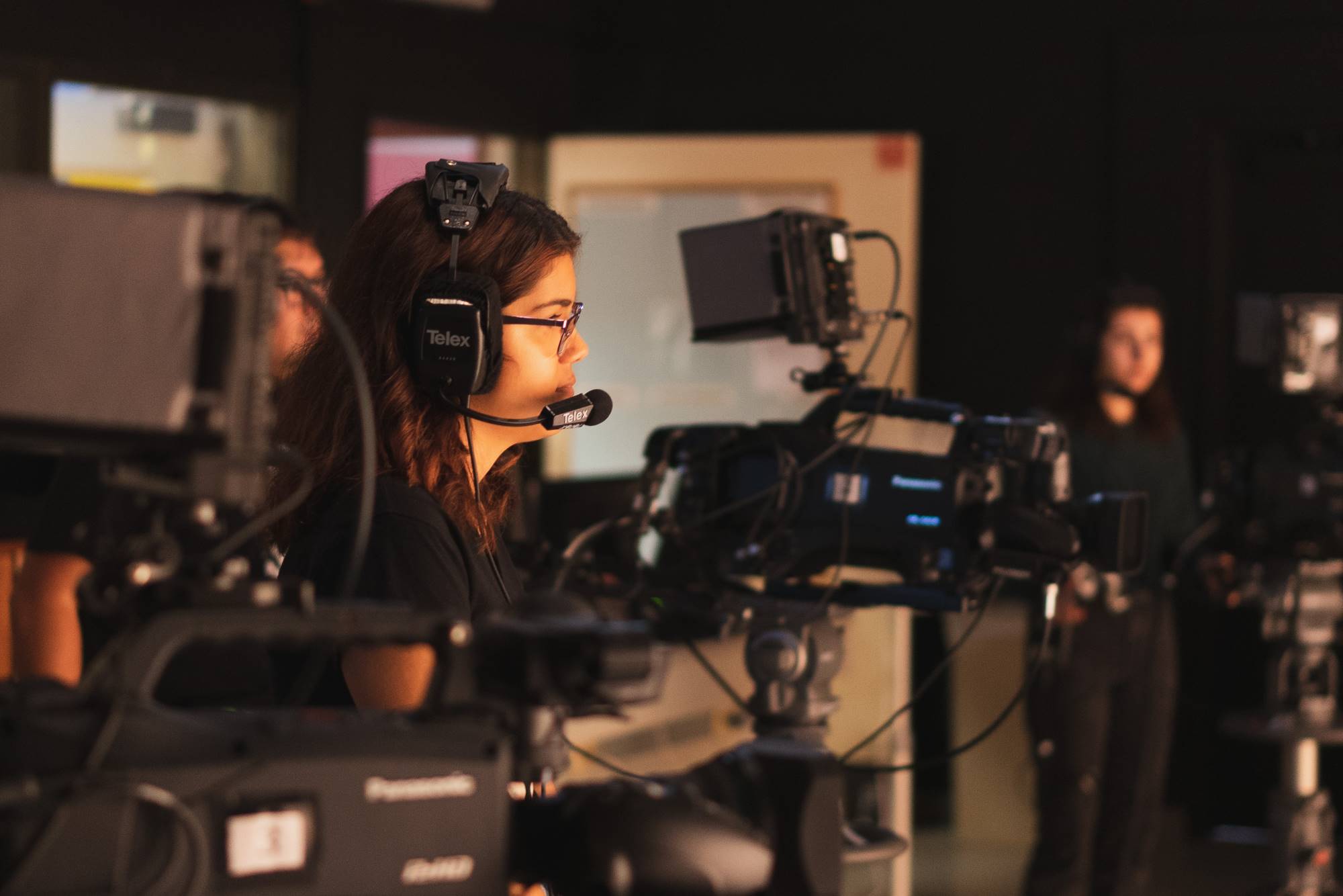 A broadcast and cinema student operates a video camera.