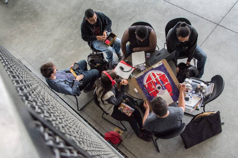 Students hang out in the Center for the Arts building.