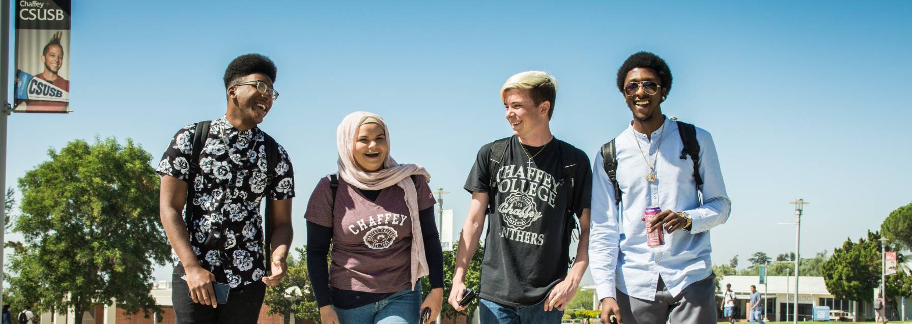 four students walking on campus