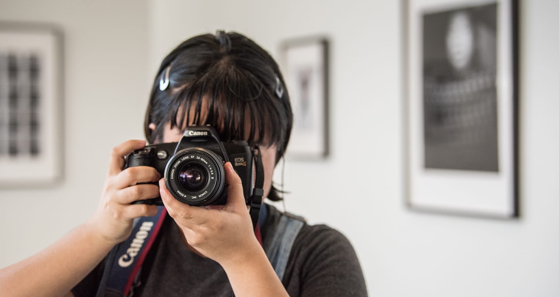 A student takes a picture with a Canon camera.