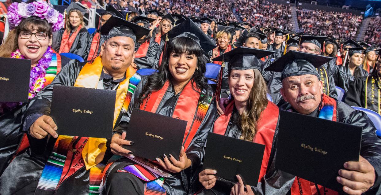 A diverse group of students walk on campus.