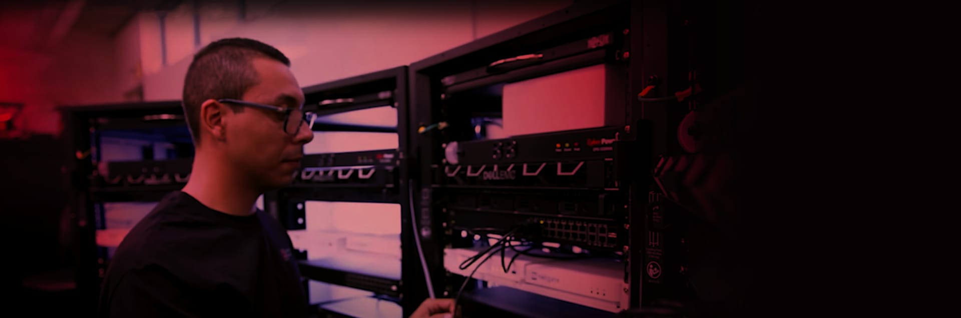 Cybersecurity student examines servers during a class.