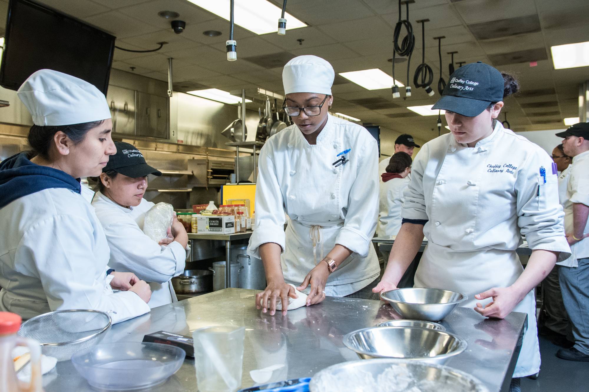 Students prepare food in a culinary arts class.