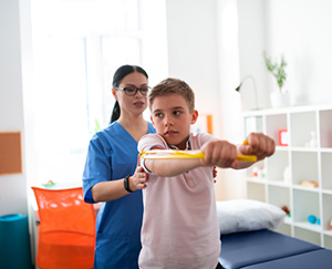 Resolute short-haired young boy showing his forces while exercising