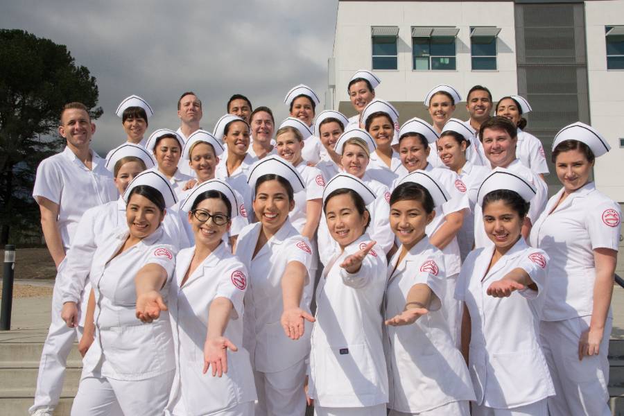 A group photo of nursing students in uniform.