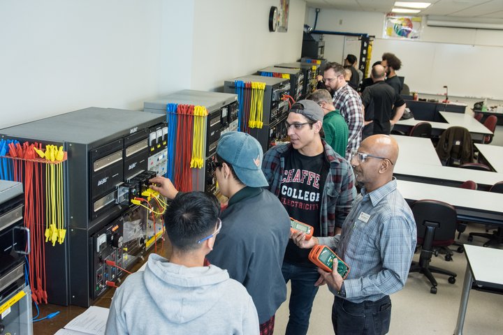 Students work in an industrial electrical technology course.