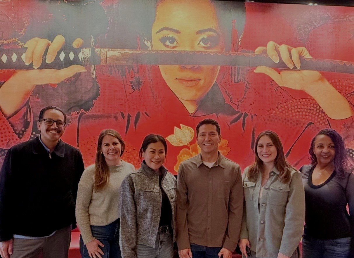 Chaffey Sociology Faculty standing in front of artwork
