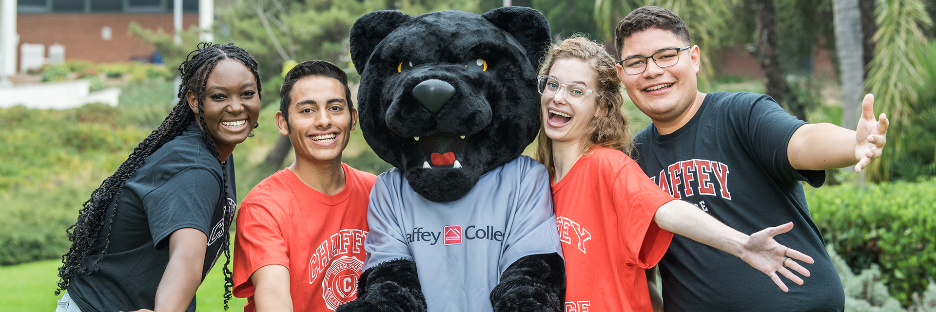 Panther mascot standing in the middle of students