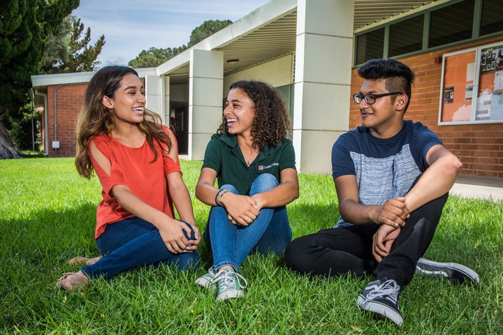 Students sit on the grass at the Rancho Cucamonga campus.