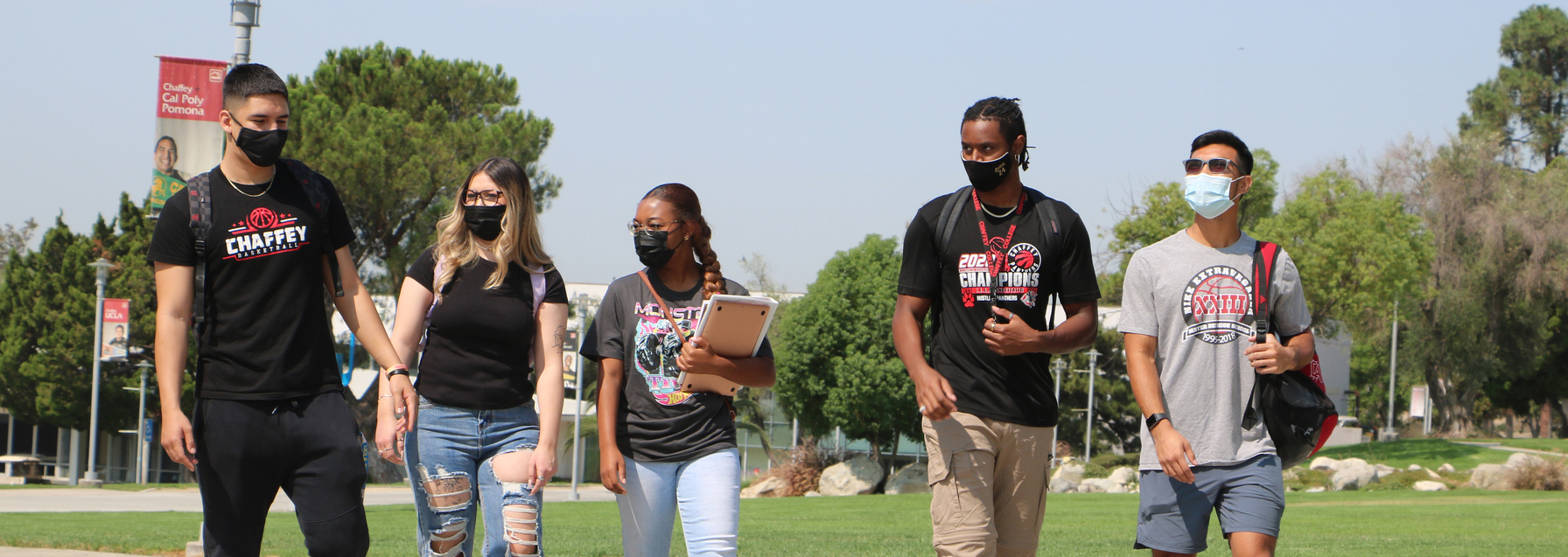 students walking on campus wearing masks