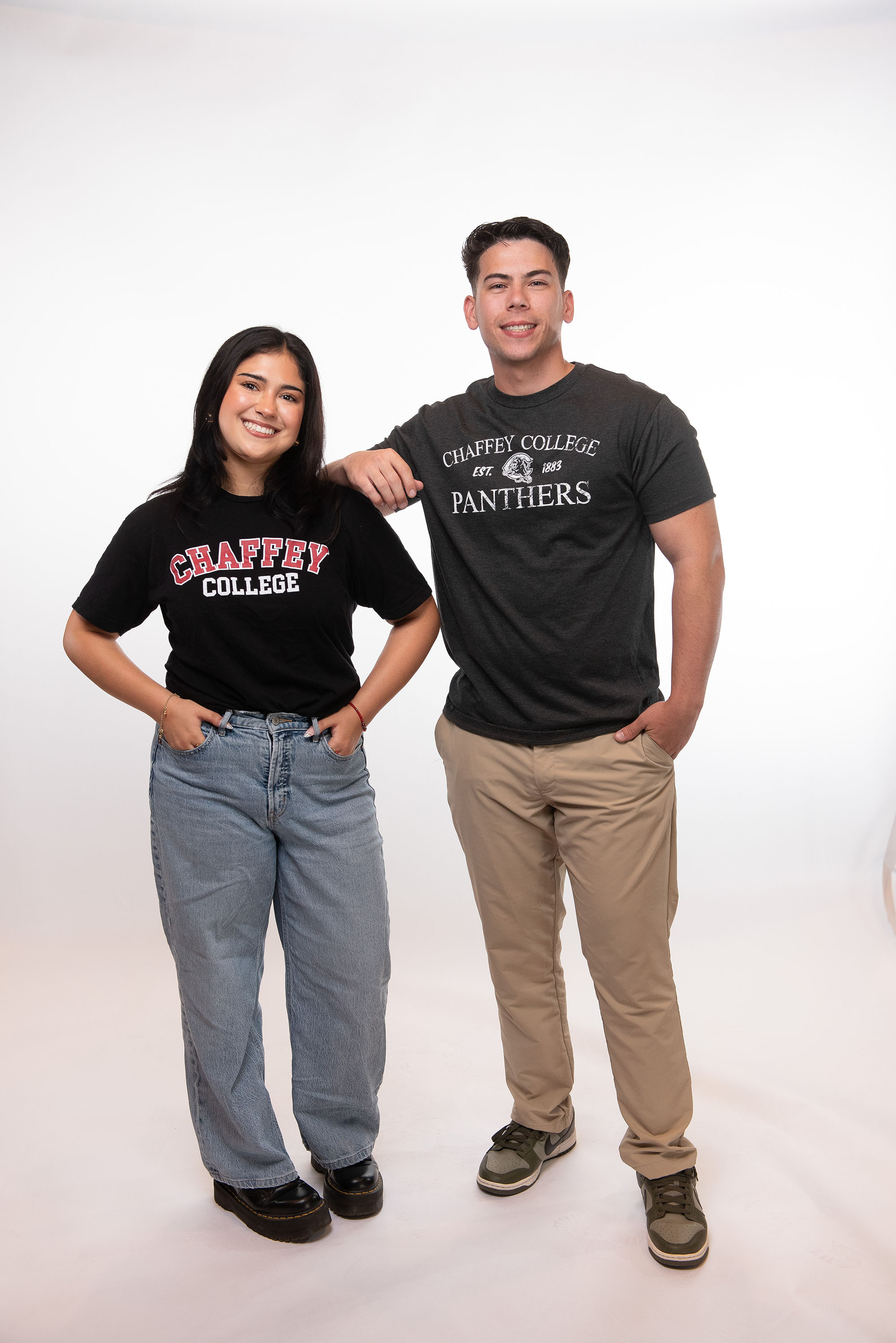 Smiling female and male students looking at each other