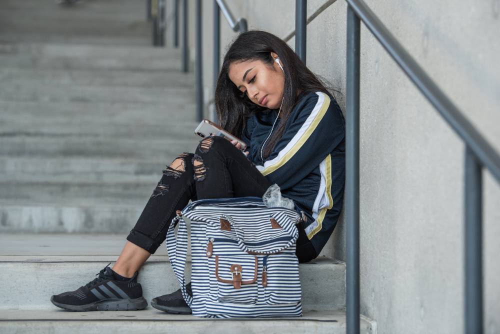 student looking at her cellphone