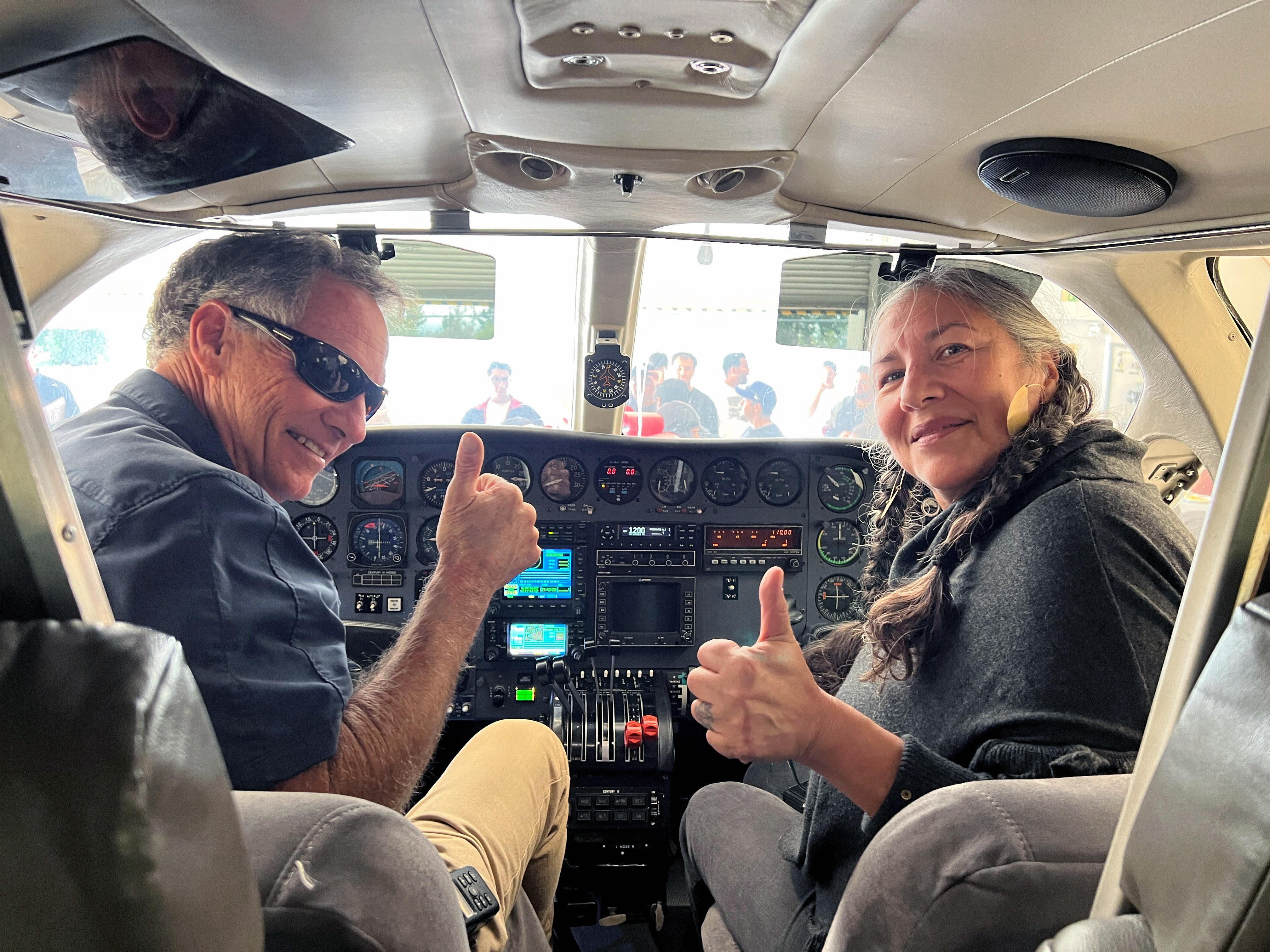 Troy Ament and Laura Crespo give a thumbs up from the cockpit of Chaffey's newest Cessna