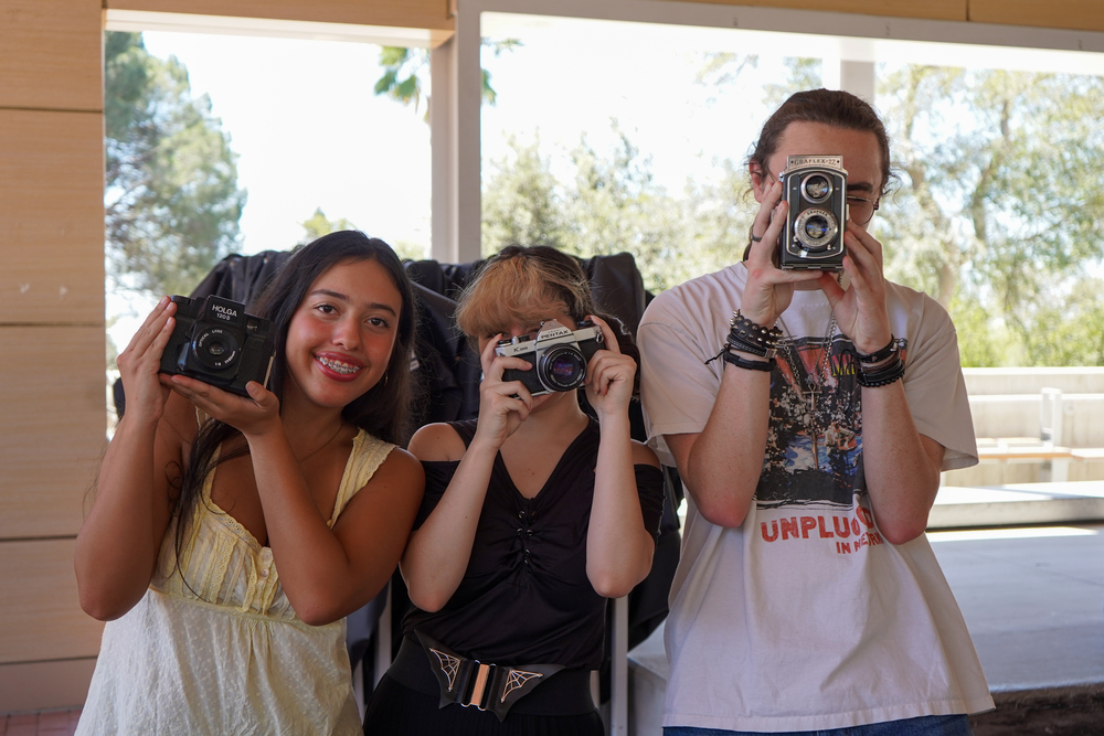 Photography Club members pose with cameras.