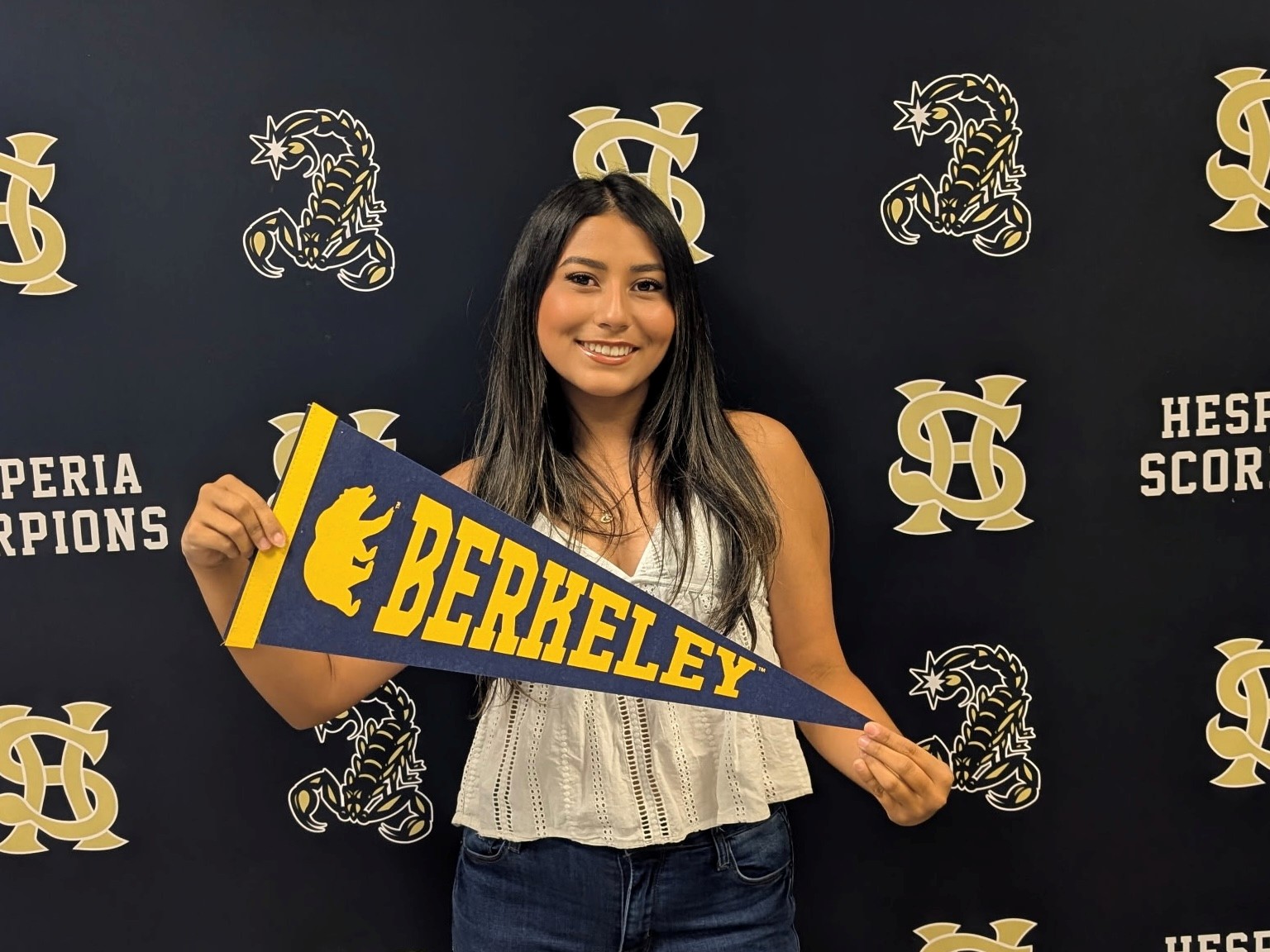 Hailey Contreras holds up a UC Berkeley pennant