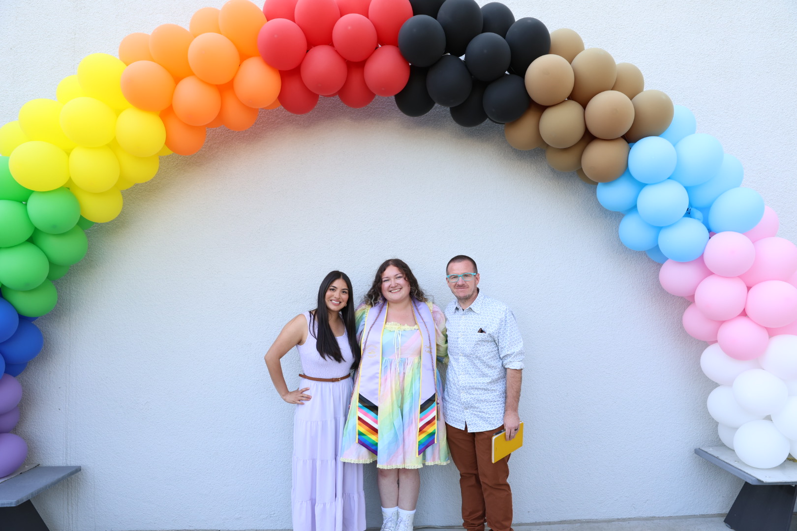 Cultural Graduations 2026 Participants in the Lavender Cultural Celebration pose under a balloon rainbow