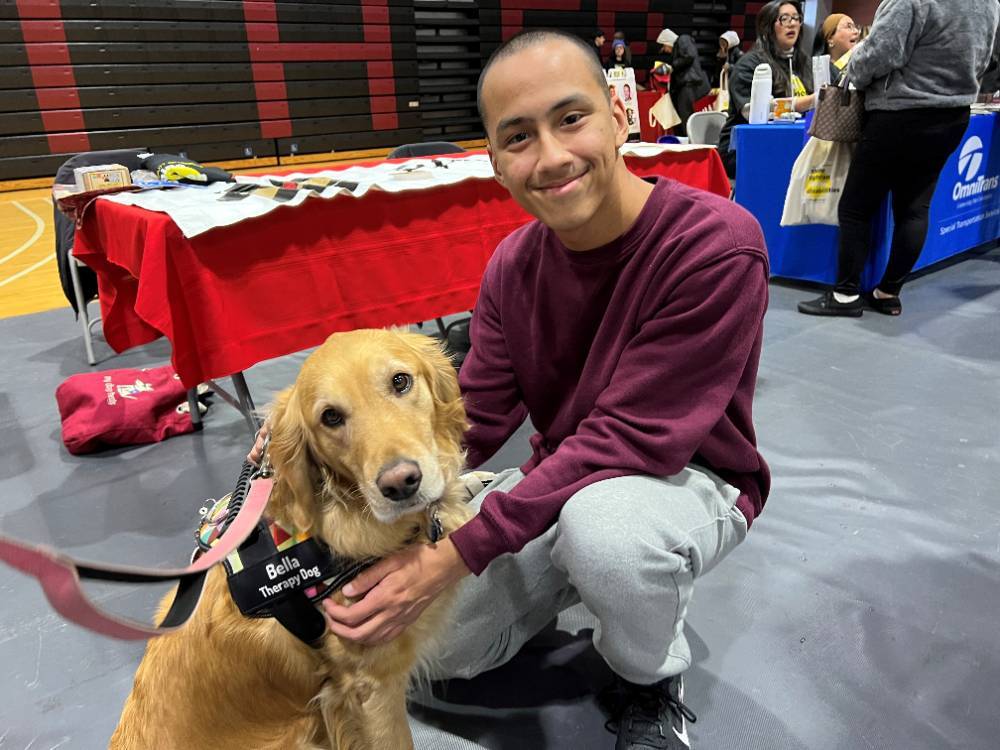 A Chaffey student poses with a disability dog.