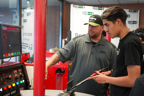 A Kaiser High School student uses a welding simulator at Manufacturing Day.