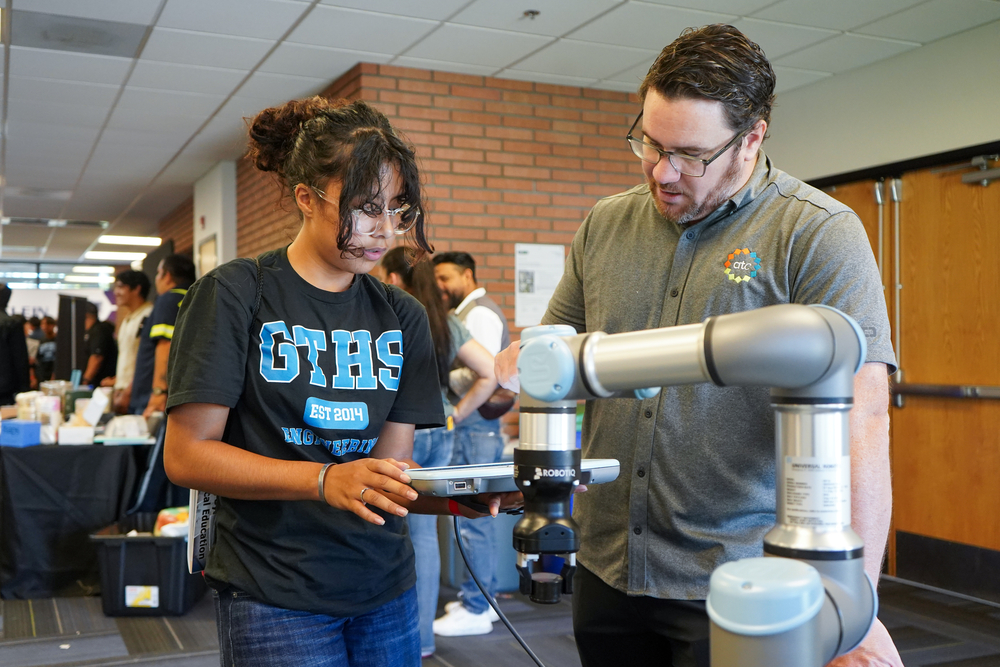 A Grand Terrace High School student learns how to operate a robotic arm.