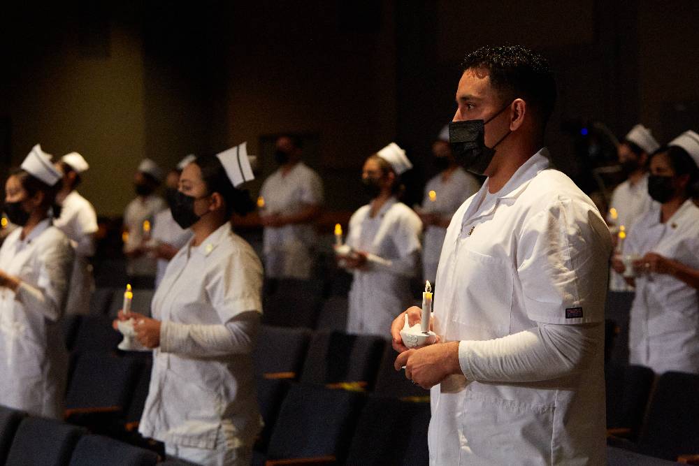Students recite the "Nightingale Pledge" during the associate degree in nursing pinning ceremony.
