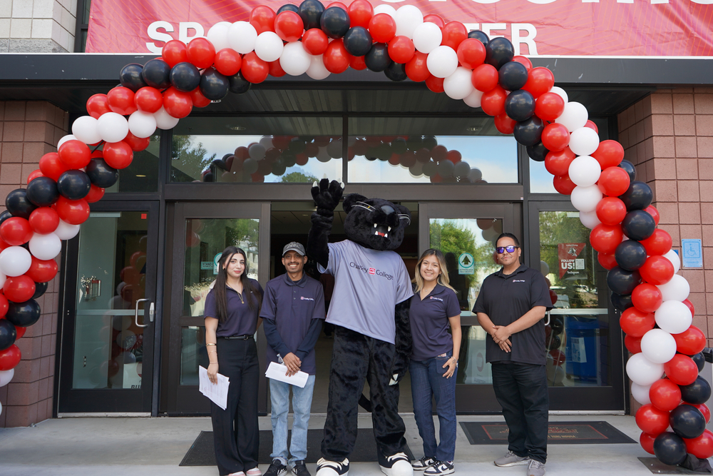 Students pose with the Panther in front of Chaffey's Sports Center.