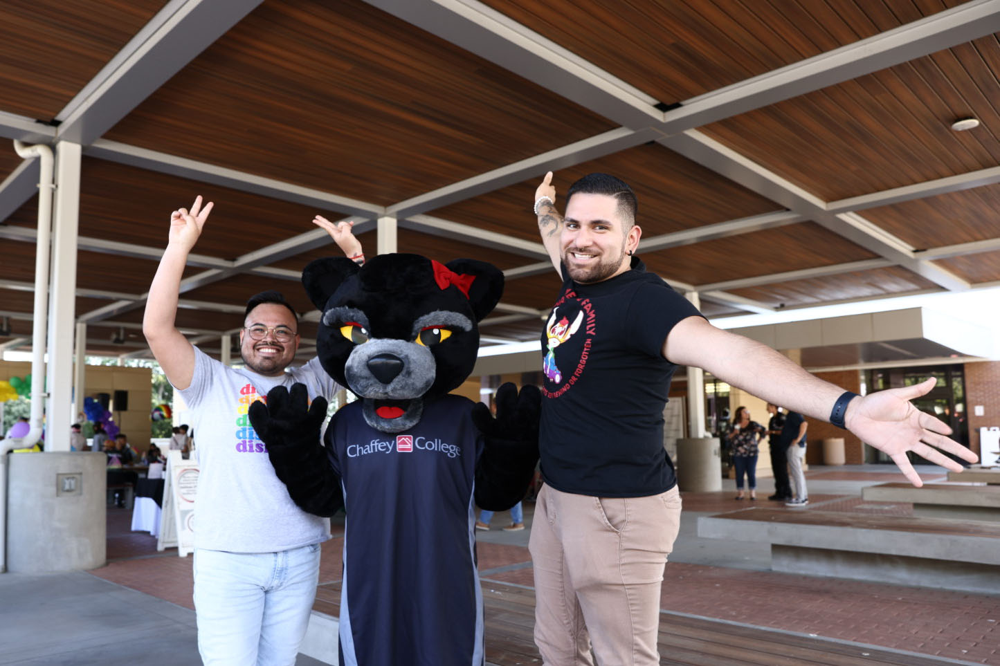 Pride Celebration attendees pose for a photo with Roxy the Panther