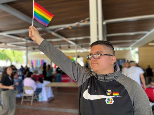 A student holds a Pride flag at Chaffey