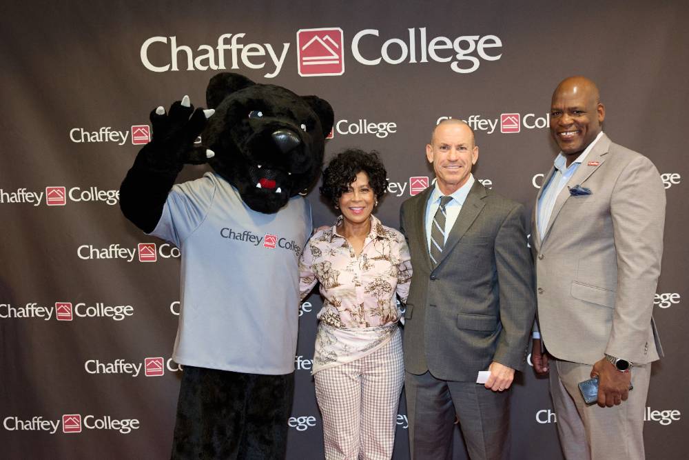 Community leaders pose with the Panther at Report to the Community