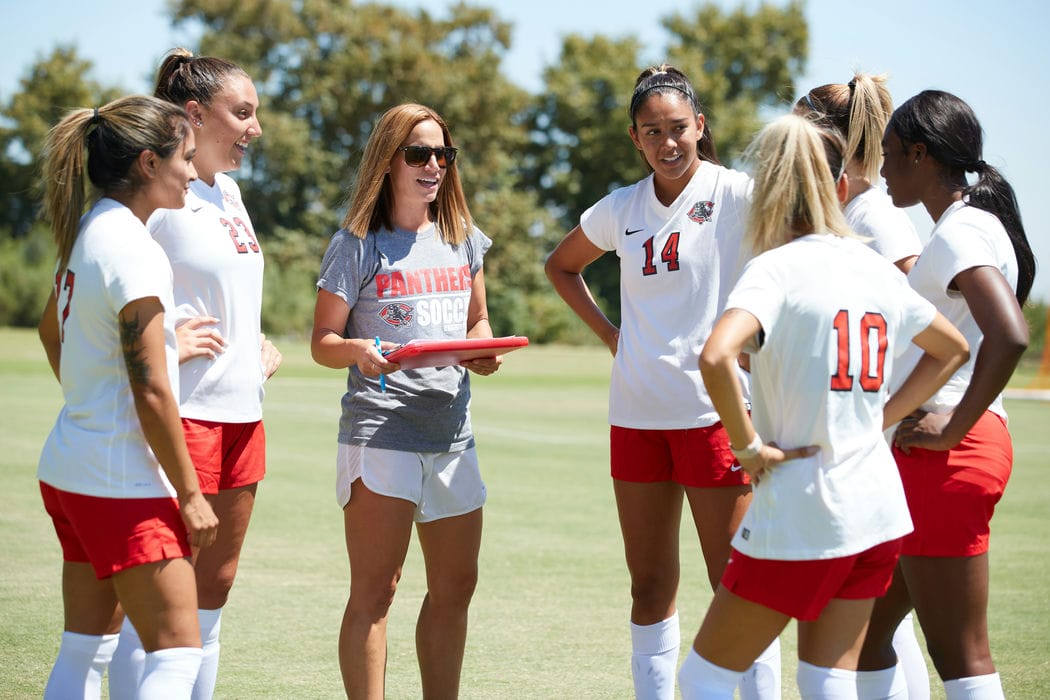 Women's soccer players gather.