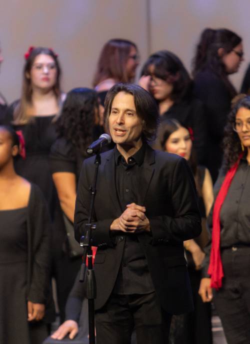 David Rentz addresses the audience during the 'Darkness and Light' winter concert.