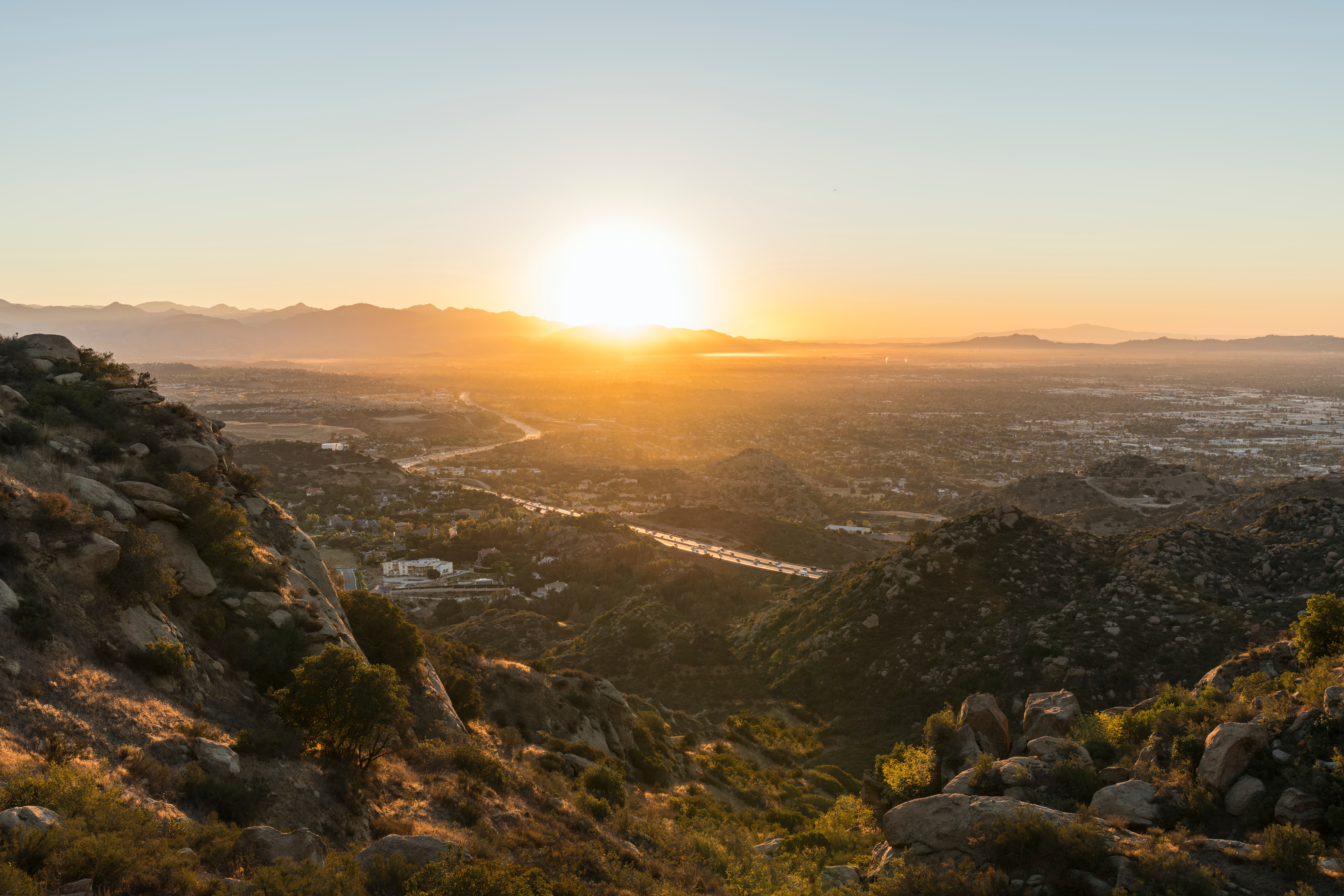 Los Angeles sunrise view of Porter Ranch and the 118 freeway in the San Fernando Valley. The San Gabriel Mountains, Burbank, and North Hollywood, California, are in the background