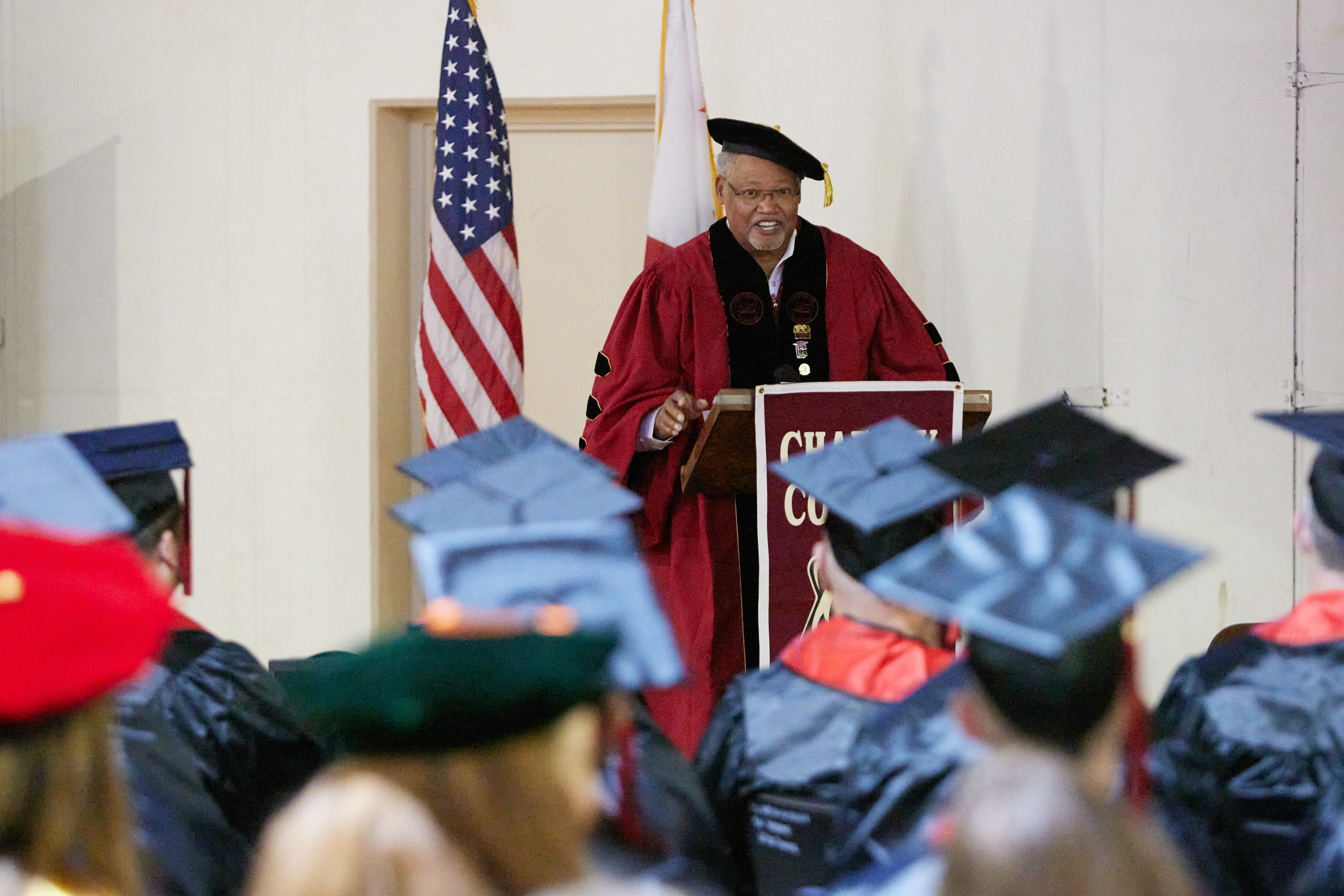 Dr Shannon at podium addressing graduates